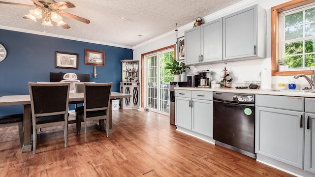 13376 Maple Rd NE, Thornville, OH 43076 - kitchen featuring dishwasher, ornamental molding, light wood finished floors, a textured ceiling, and light countertops
