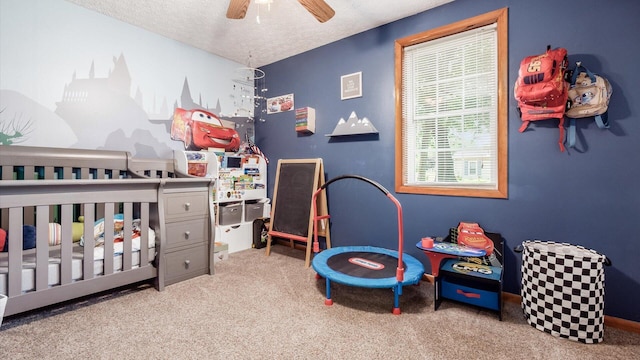13376 Maple Rd NE, Thornville, OH 43076 - bedroom with carpet flooring, a nursery area, a textured ceiling, and ceiling fan