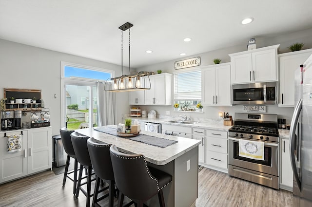 172 Rosewood Loop SE, Commercial Point, OH 43116 - kitchen featuring appliances with stainless steel finishes, a center island, healthy amount of natural light, light countertops, and recessed lighting