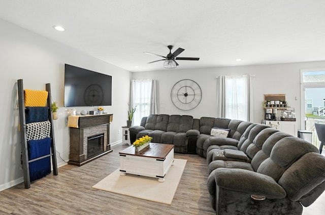 172 Rosewood Loop SE, Commercial Point, OH 43116 - living area with ceiling fan, wood finished floors, recessed lighting, and a glass covered fireplace
