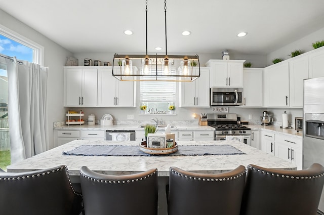 172 Rosewood Loop SE, Commercial Point, OH 43116 - kitchen featuring stainless steel appliances, a breakfast bar area, recessed lighting, white cabinetry, and decorative light fixtures