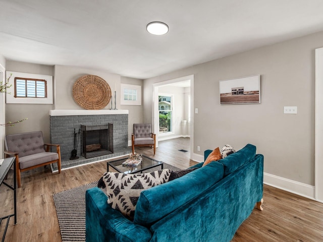2040 Fairmont Ave, Columbus, OH 43223 - living room with healthy amount of natural light, a brick fireplace, and wood finished floors