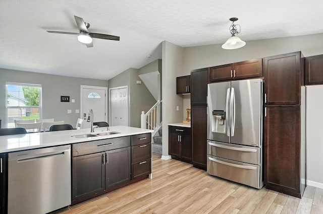 6803 Alex Dr, Canal Winchester, OH 43110 - kitchen featuring appliances with stainless steel finishes, vaulted ceiling, light countertops, light wood-type flooring, and dark brown cabinets