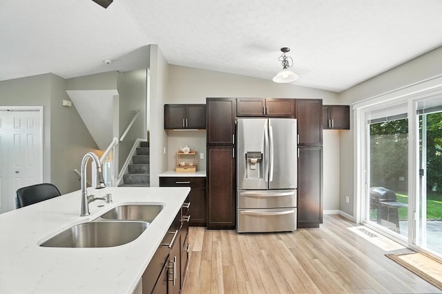 6803 Alex Dr, Canal Winchester, OH 43110 - kitchen featuring stainless steel fridge with ice dispenser, lofted ceiling, light wood finished floors, light stone countertops, and decorative light fixtures