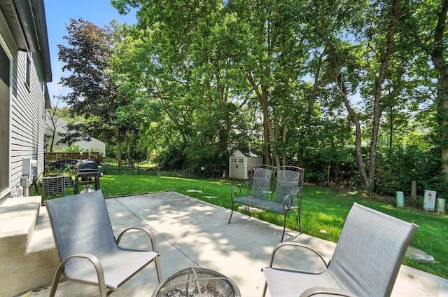 6803 Alex Dr, Canal Winchester, OH 43110 - view of patio / terrace featuring a fire pit, a shed, grilling area, and view of scattered trees