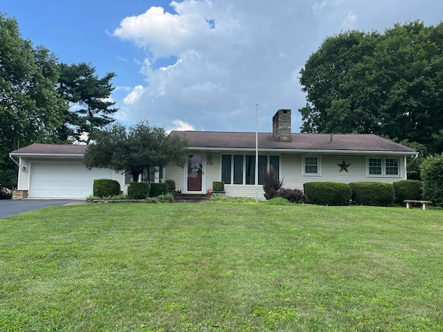 784 Colonial Dr, Heath, OH 43056 - ranch-style house featuring a chimney, driveway, a garage, and a front lawn