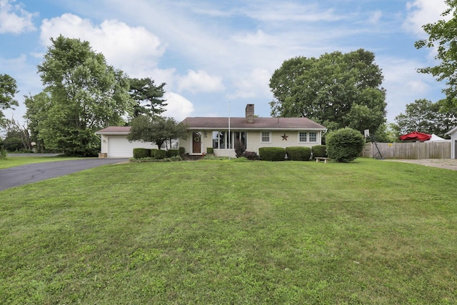 784 Colonial Dr, Heath, OH 43056 - single story home featuring asphalt driveway, a chimney, and a garage