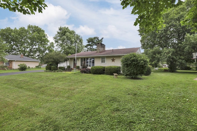 784 Colonial Dr, Heath, OH 43056 - ranch-style home featuring a front yard and a chimney