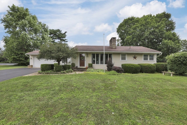 784 Colonial Dr, Heath, OH 43056 - ranch-style house featuring a chimney, driveway, a garage, and a front yard