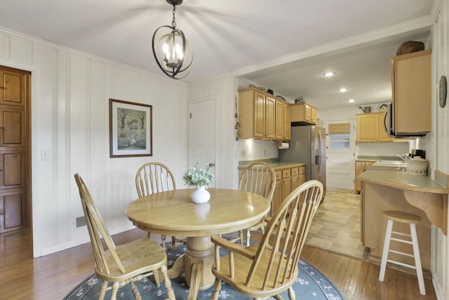784 Colonial Dr, Heath, OH 43056 - dining area featuring crown molding, light wood finished floors, a chandelier, and recessed lighting