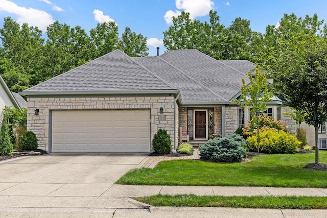 5232 Lola Way, Columbus, OH 43235 - view of front facade with stone siding, roof with shingles, an attached garage, a front yard, and driveway