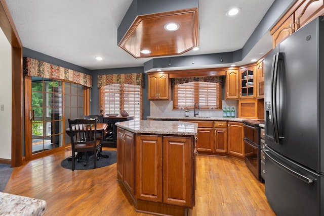 5232 Lola Way, Columbus, OH 43235 - kitchen with fridge with ice dispenser, electric stove, brown cabinetry, light wood-type flooring, and recessed lighting