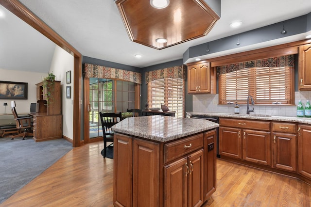 5232 Lola Way, Columbus, OH 43235 - kitchen featuring a kitchen island, brown cabinetry, backsplash, and light stone countertops