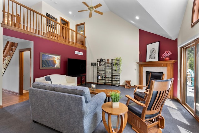 5232 Lola Way, Columbus, OH 43235 - carpeted living area with high vaulted ceiling, a ceiling fan, a fireplace, stairs, and recessed lighting