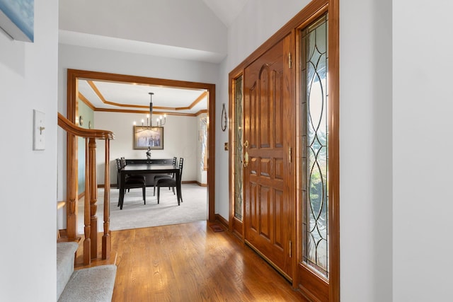 5232 Lola Way, Columbus, OH 43235 - foyer featuring a chandelier, crown molding, light wood finished floors, and healthy amount of natural light