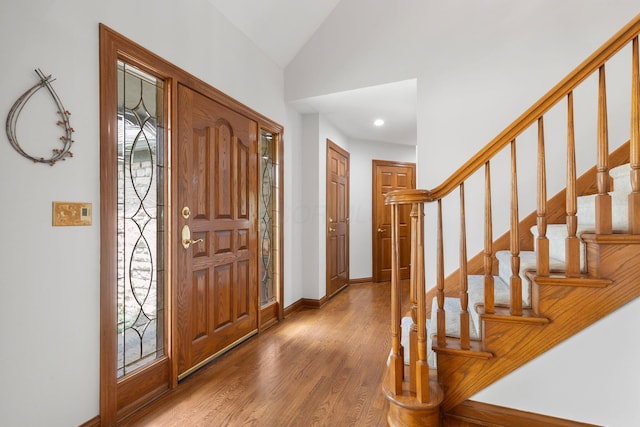 5232 Lola Way, Columbus, OH 43235 - foyer entrance featuring wood finished floors, vaulted ceiling, stairs, and recessed lighting