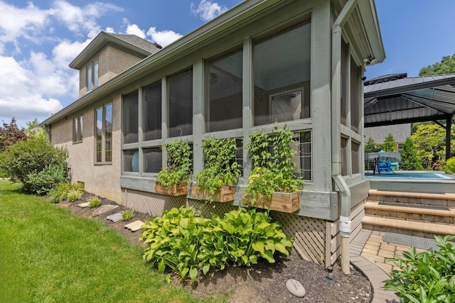 5232 Lola Way, Columbus, OH 43235 - view of side of home featuring a gazebo, an outdoor pool, stucco siding, and a sunroom