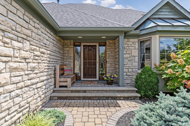 5232 Lola Way, Columbus, OH 43235 - entrance to property with roof with shingles, stone siding, and a porch