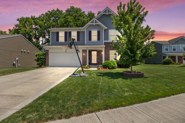 3810 Winding Path Dr, Canal Winchester, OH 43110 - view of front of house featuring concrete driveway, a yard, a garage, and brick siding