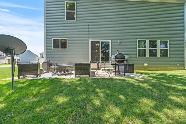3810 Winding Path Dr, Canal Winchester, OH 43110 - back of property with a patio area, a lawn, and an outdoor living space with a fire pit