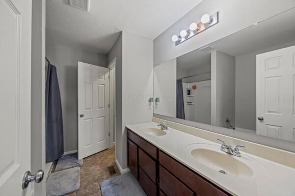 3810 Winding Path Dr, Canal Winchester, OH 43110 - full bathroom featuring double vanity and a shower with shower curtain