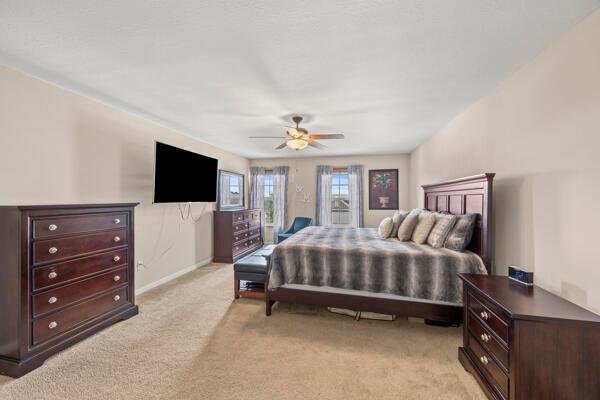 3810 Winding Path Dr, Canal Winchester, OH 43110 - bedroom with light colored carpet and ceiling fan
