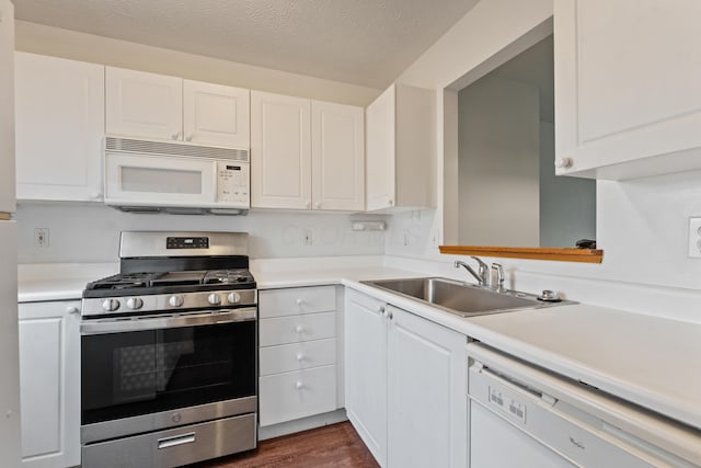 5692 Palos Ln Unit 168D, Hilliard, OH 43026 - kitchen featuring white appliances, light countertops, white cabinetry, and a textured ceiling