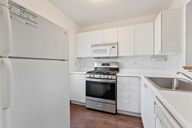 5692 Palos Ln Unit 168D, Hilliard, OH 43026 - kitchen with white appliances, dark wood finished floors, white cabinetry, light countertops, and a textured ceiling