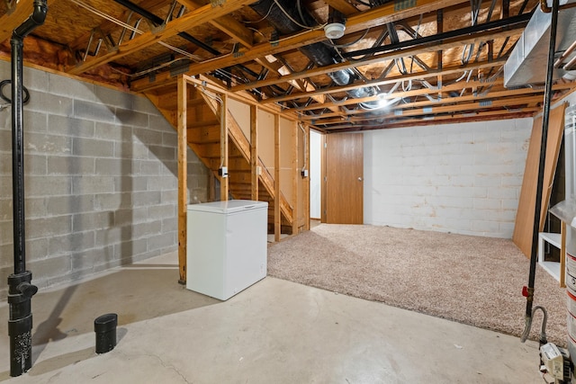 5692 Palos Ln Unit 168D, Hilliard, OH 43026 - unfinished below grade area with fridge, concrete block wall, and stairs