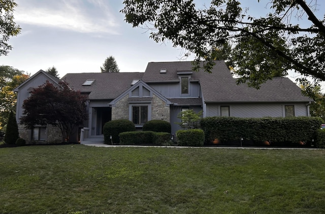 8025 Inistork Dr, Dublin, OH 43017 - craftsman-style home featuring stone siding, a front lawn, and roof with shingles