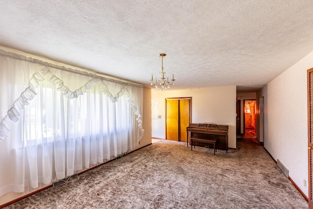 2052 Lorimer Dr NE, Newark, OH 43055 - carpeted empty room with a chandelier and a textured ceiling