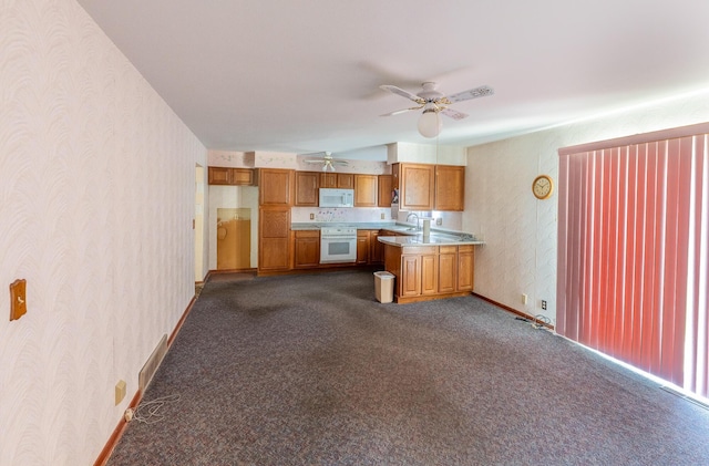 2052 Lorimer Dr NE, Newark, OH 43055 - kitchen with wallpapered walls, light countertops, wall oven, a ceiling fan, and white microwave