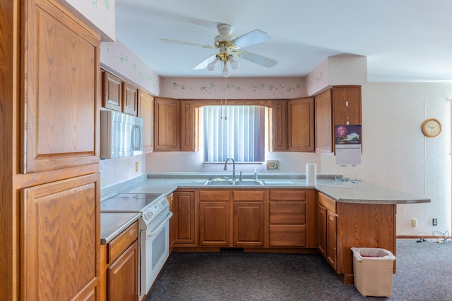 2052 Lorimer Dr NE, Newark, OH 43055 - kitchen with white appliances, a peninsula, brown cabinets, ceiling fan, and wallpapered walls