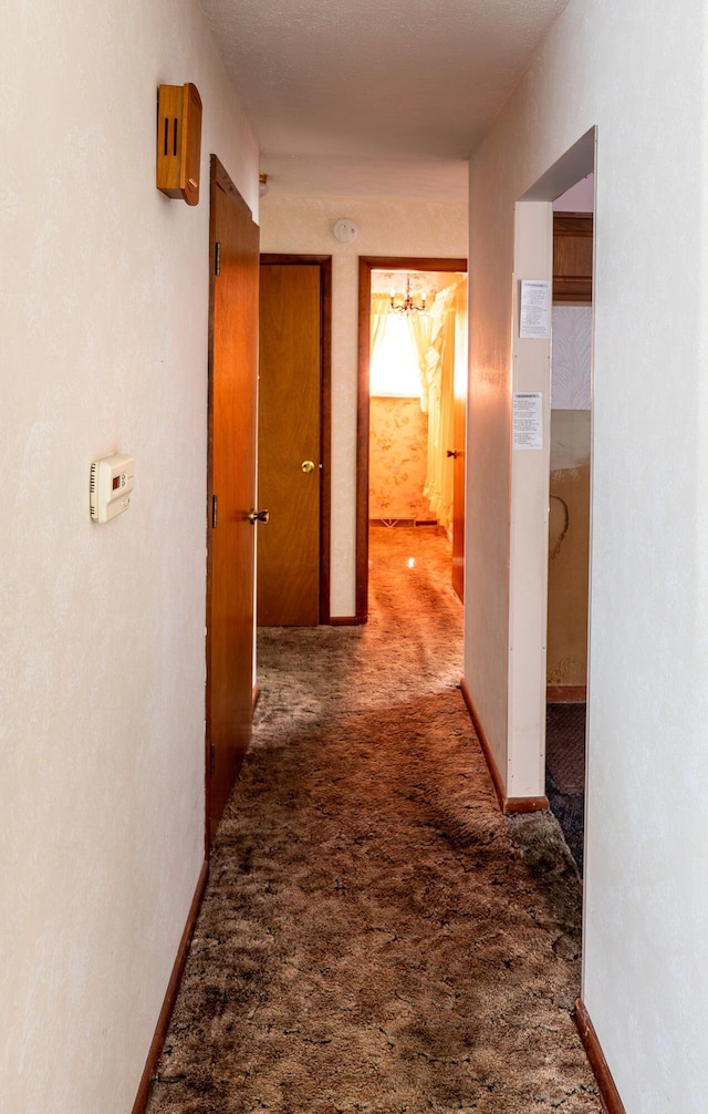 2052 Lorimer Dr NE, Newark, OH 43055 - hallway with carpet floors and a chandelier