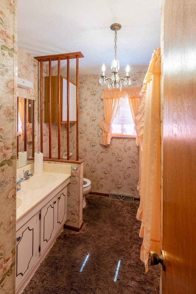 2052 Lorimer Dr NE, Newark, OH 43055 - bathroom featuring a chandelier, vanity, and wallpapered walls