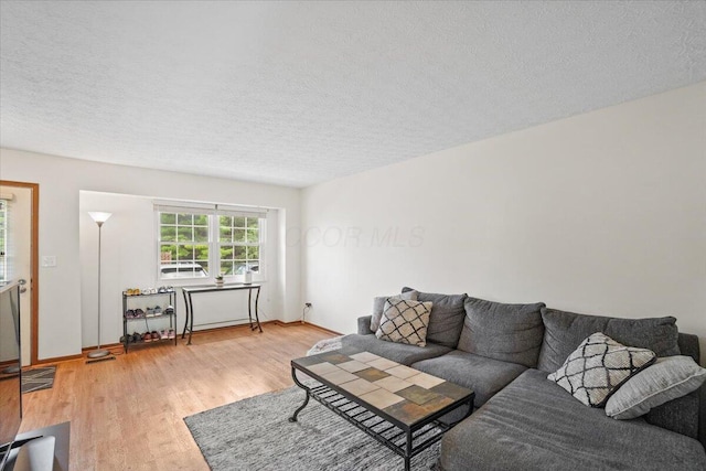 907 Soramill Ln Unit 8E, Columbus, OH 43085 - living area with light wood-style floors and a textured ceiling