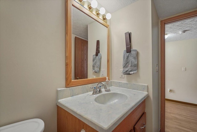 907 Soramill Ln Unit 8E, Columbus, OH 43085 - bathroom with a textured ceiling, vanity, and wood finished floors