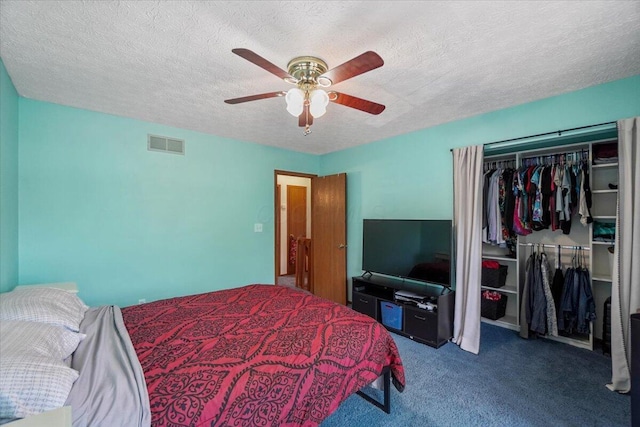 907 Soramill Ln Unit 8E, Columbus, OH 43085 - carpeted bedroom with a closet, a textured ceiling, and a ceiling fan
