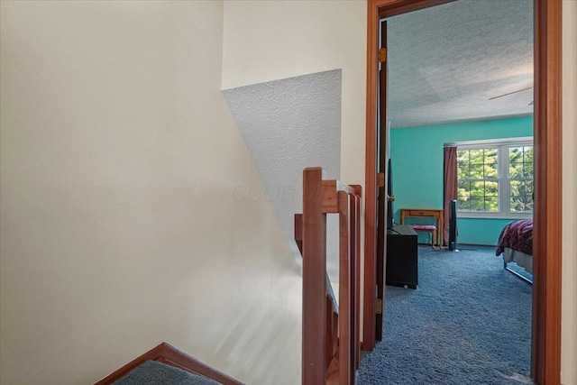 907 Soramill Ln Unit 8E, Columbus, OH 43085 - staircase with carpet floors and a textured ceiling