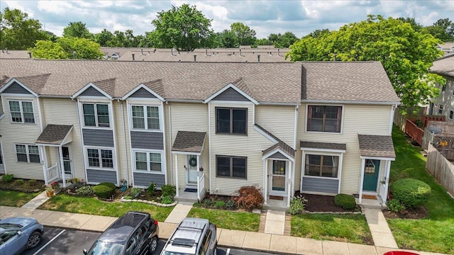 907 Soramill Ln Unit 8E, Columbus, OH 43085 - view of property featuring uncovered parking, roof with shingles, and entry steps