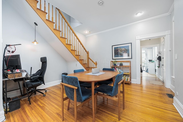 133 E Sycamore St, Columbus, OH 43206 - dining space with light wood-style floors, a desk, stairway, crown molding, and recessed lighting