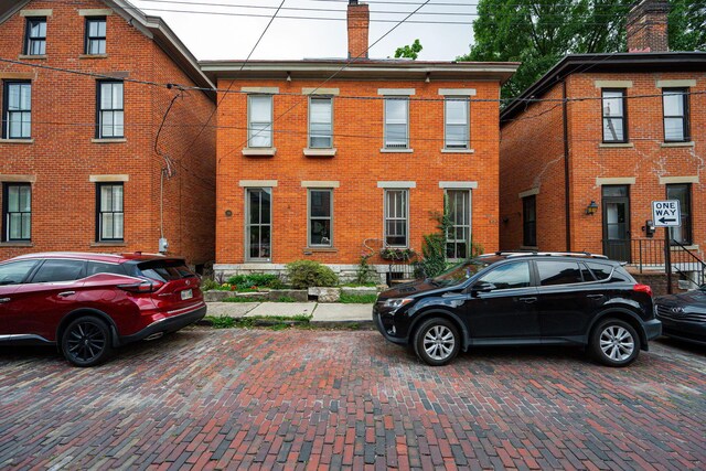133 E Sycamore St, Columbus, OH 43206 - view of front facade with a chimney and brick siding