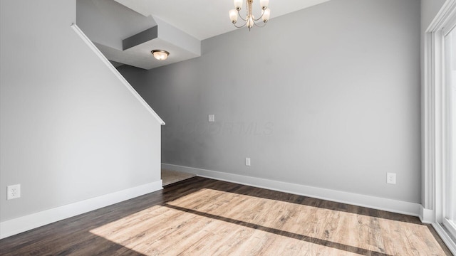 1968 Highbridge St, Newark, OH 43055 - empty room featuring dark wood-type flooring, a chandelier, and stairs