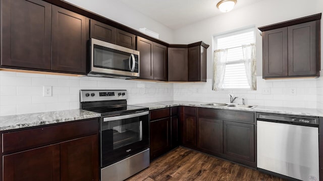 1968 Highbridge St, Newark, OH 43055 - kitchen featuring stainless steel appliances, dark brown cabinets, light stone counters, and dark wood-style flooring