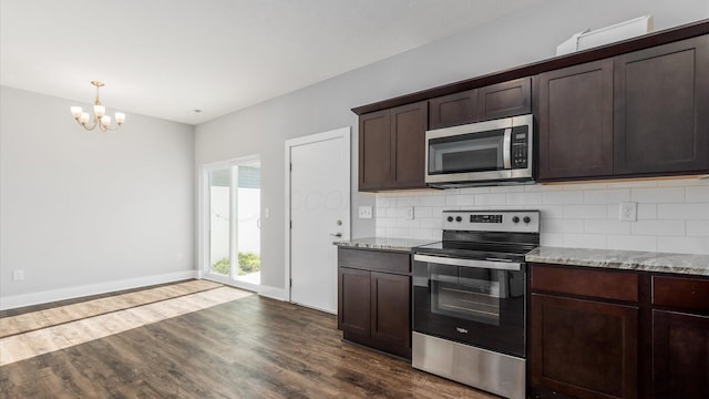 1968 Highbridge St, Newark, OH 43055 - kitchen with stainless steel appliances, a chandelier, dark wood finished floors, and backsplash