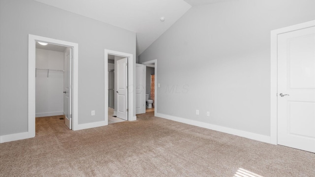 1968 Highbridge St, Newark, OH 43055 - unfurnished bedroom with a walk in closet, carpet, vaulted ceiling, a closet, and ensuite bathroom