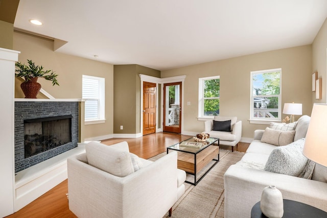 1293 Avondale Ave, Columbus, OH 43212 - living room with a fireplace with raised hearth, light wood-type flooring, and recessed lighting