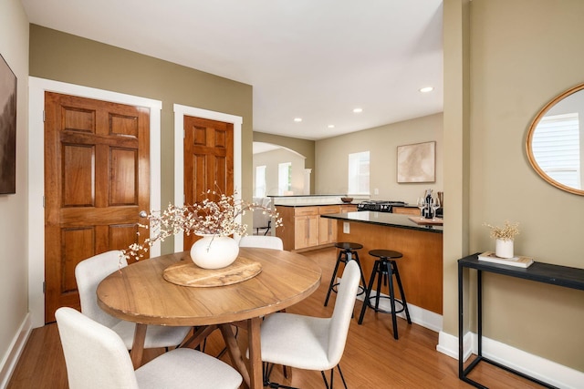 1293 Avondale Ave, Columbus, OH 43212 - dining area featuring arched walkways, light wood-type flooring, and recessed lighting