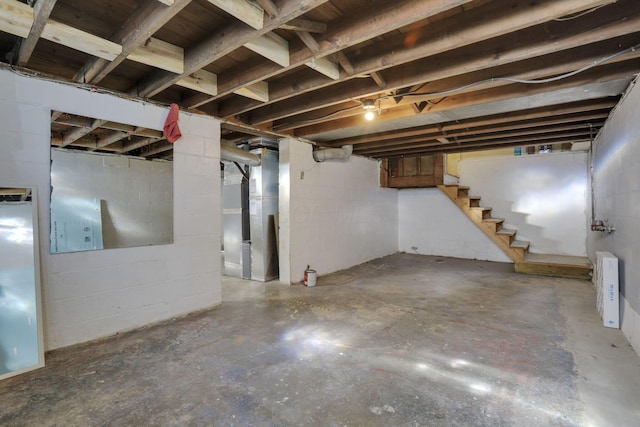 977 Sells Ave, Columbus, OH 43212 - unfinished below grade area with heating unit, stairs, and concrete block wall