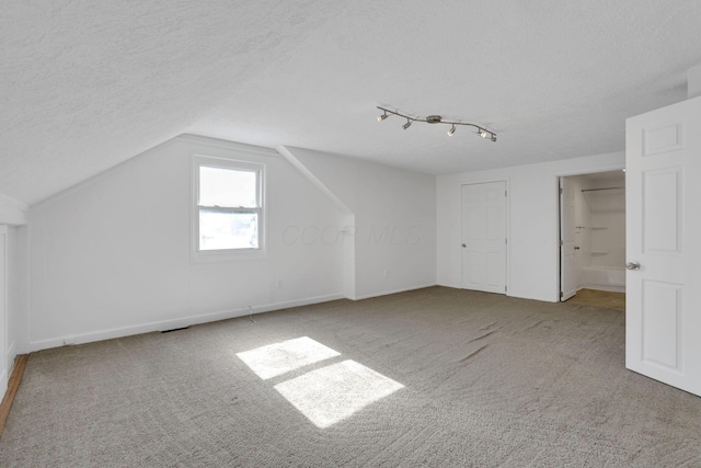 977 Sells Ave, Columbus, OH 43212 - additional living space with carpet, a textured ceiling, and vaulted ceiling